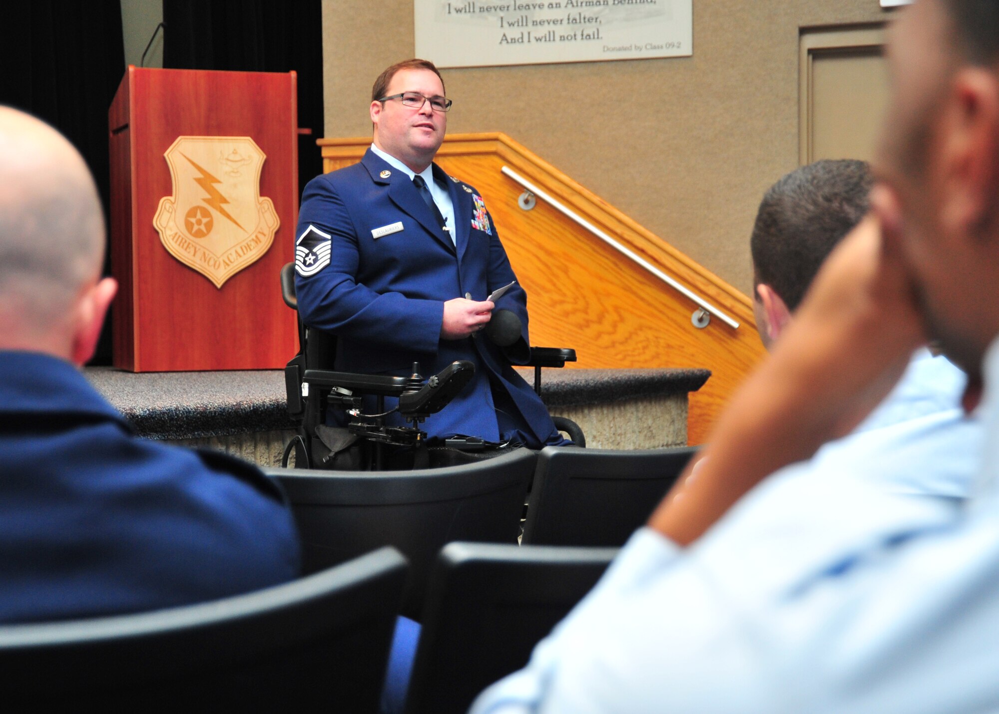 Master Sgt. Joe Deslauriers, 1st Special Operations Civil Engineer Squadron explosive ordnance disposal technician, at Hurlburt Field, Fla., talks about his experience and recovery to Paul Airey NCO Academy class 14-1 Dec19, in the NCOA auditorium. Deslauriers was awarded the Silver Star after losing both his legs and left arm during a 2011 deployment to Afghanistan. (U.S. Air Force photo by Airman 1st Class Sergio A. Gamboa)