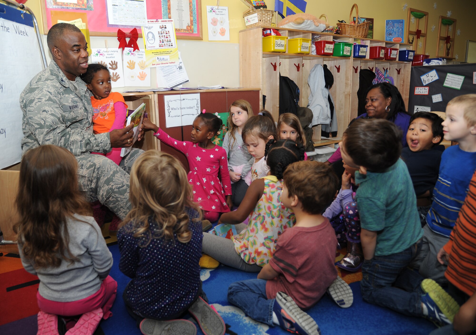 Col. Mark Vivians, 81st Mission Support Group commander, reads to a classroom of three-to-five year old children at the child development center Dec. 19, 2013, at Keesler Air Force Base, Miss.  Other leadership from the 81st Training Wing also spent time reading books to children at the CDC.  (U.S. Air Force photo by Kemberly Groue)