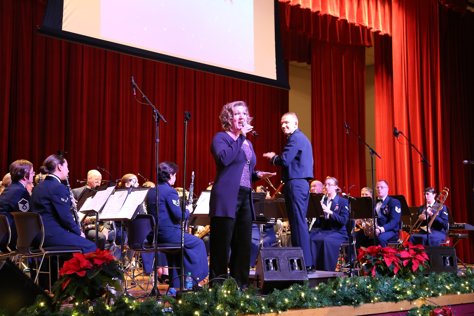 Air Force Master Sgt. Nancy Poffenbarger, Air Force Band of the West vocalist, sings a variety of holiday songs with members of the Air Force Band of the West Dec. 17 at the Joint Base San Antonio-Lackland Bob Hope Theater. (U.S. Air Force photo by Airman 1st Class Lincoln Korver)