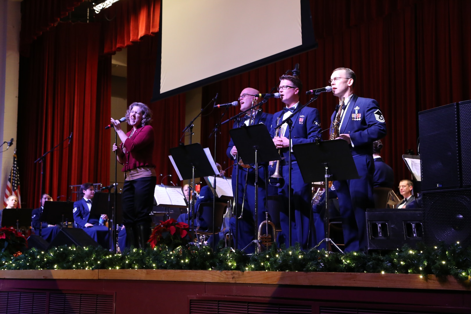 Air Force Master Sgt. Nancy Poffenbarger, Air Force Band of the West vocalist, sings a variety of holiday songs with members of the Air Force Band of the West’s musical ensemble “Warhawk” Dec. 17 at the Joint Base San Antonio-Lackland Bob Hope Theater. (U.S. Air Force photo by Airman 1st Class Lincoln Korver)