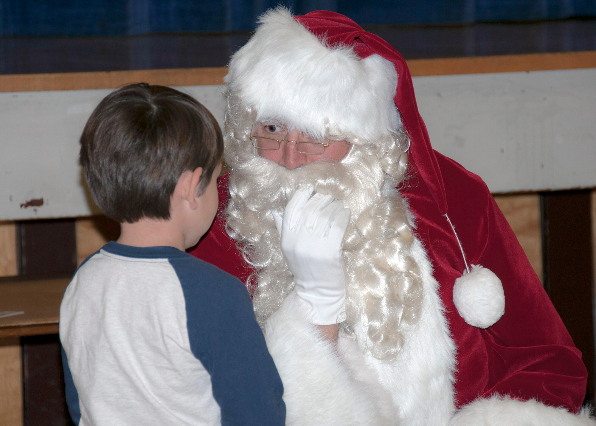 TRAVIS AIR FORCE BASE, Calif. -- For nearly three decades, members of Team Travis have been participating in Operation Teddy Bear. This year, the 349th Medical Group hosted the event and had more than 25 volunteers. Airmen visited local Solano County kindergarten children and distributed 480 gift bags filled with Teddy bears, candy canes, juice boxes, toys, and pencils. The children also got an unexpected surprise; a visit from Santa himself. Chief Master Sgt. Louis Kloeppel, or as he's known to the children, "Santa," listened as each child whispered their Christmas gift wishes in his ear. (U.S. Air Force photo/Staff Sgt. Amelia Leonard)