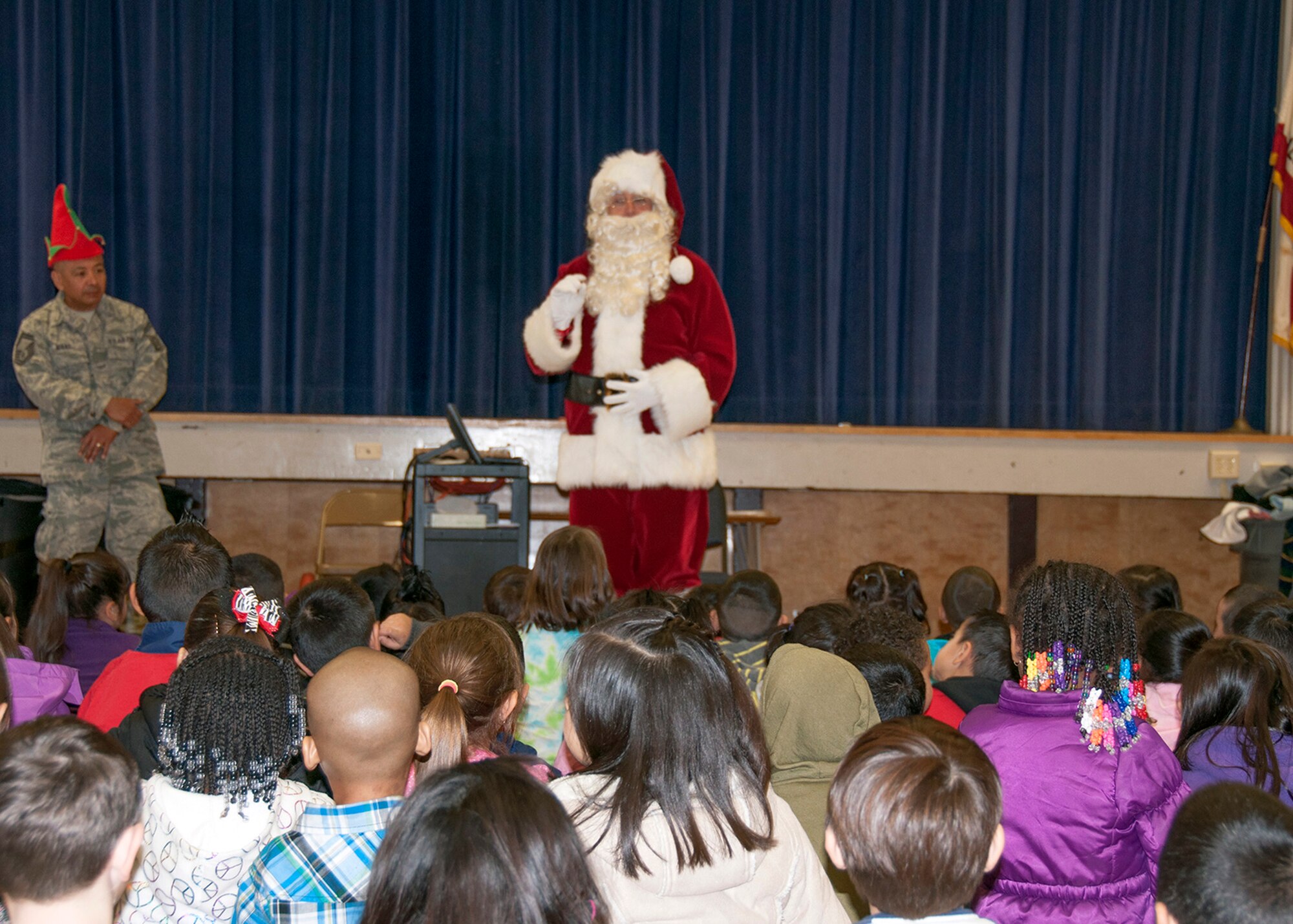 TRAVIS AIR FORCE BASE, Calif. -- For nearly three decades, members of Team Travis have been participating in Operation Teddy Bear. This year, the 349th Medical Group hosted the event and had more than 25 volunteers. Airmen visited local Solano County kindergarten children and distributed 480 gift bags filled with Teddy bears, candy canes, juice boxes, toys, and pencils. The children also got an unexpected surprise; a visit from Santa himself. Chief Master Sgt. Louis Kloeppel, or as he's known to the children, "Santa," listened as each child whispered their Christmas gift wishes in his ear. (U.S. Air Force photo/Staff Sgt. Amelia Leonard)