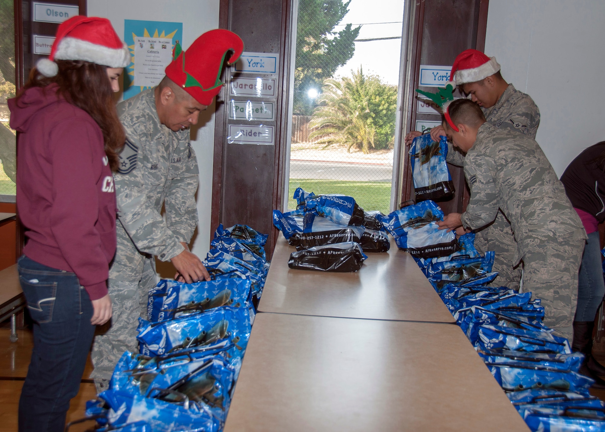 TRAVIS AIR FORCE BASE, Calif. -- For nearly three decades, members of Team Travis have been participating in Operation Teddy Bear. This year, Members of the 349th Aeromedical Staging Squadron had more than 25 volunteers. Airmen visited local Solano County kindergarten children and distributed 480 gift bags filled with Teddy bears, candy canes, juice boxes, toys, and pencils. The children also got an unexpected surprise; a visit from Santa himself. Chief Master Sgt. Louis Kloeppel, or as he's known to the children, "Santa," listened as each child whispered their Christmas gift wishes in his ear. (U.S. Air Force photo/Staff Sgt. Amelia Leonard)