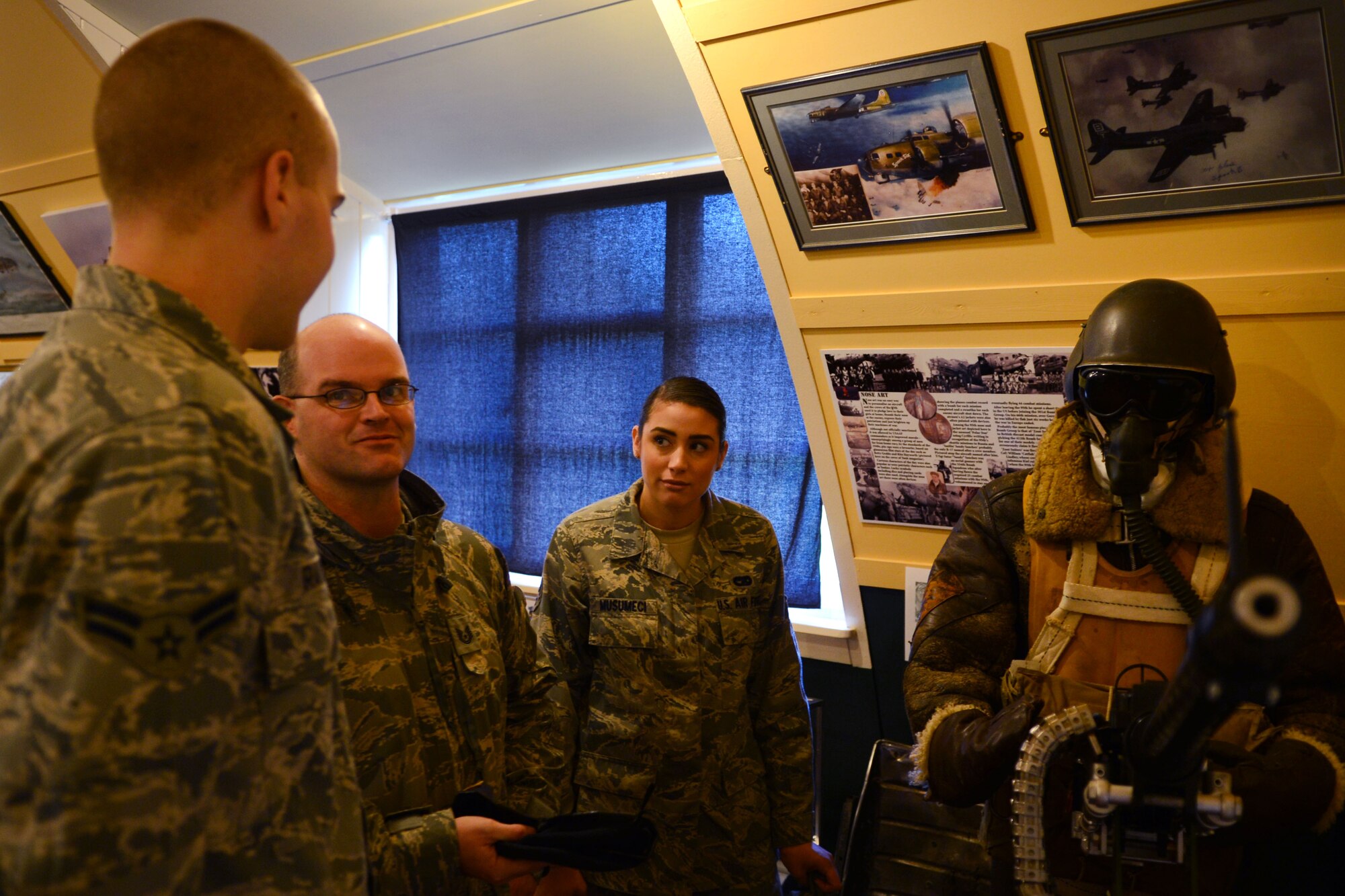 Team Mildenhall members examine a model of an aerial gunner Dec. 17, 2013, during a heritage visit to the 95th Bombardment Group Heritage Association at RAF Horham, Norfolk, England. The visit enabled Airmen to see where the roots of the U.S. Air Forces in Europe-U.K., started out. (U.S. Air Force photo by Airman 1st Class Dillon Johnston/Released)