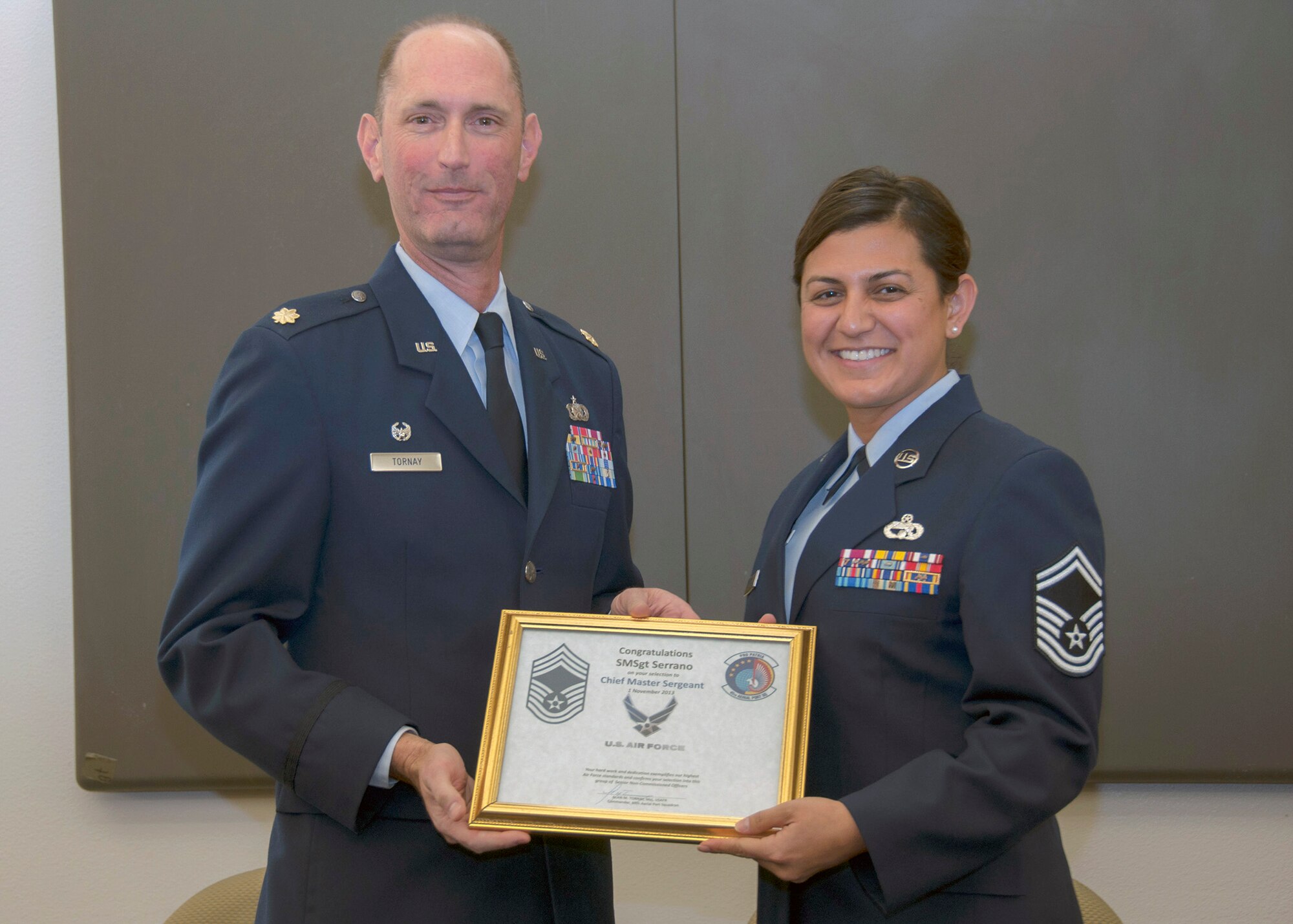 TRAVIS AIR FORCE BASE, Calif. -- Chief Master Sergeant Teresa Serrano, 45th Aerial Port Squadron, pins on the rank of Chief during a pinning-on ceremony held here at Travis Air Force Base, Calif. on Dec. 7, 2013. (U.S. Air Force photo/Staff Sgt. Amelia Leonard)
   