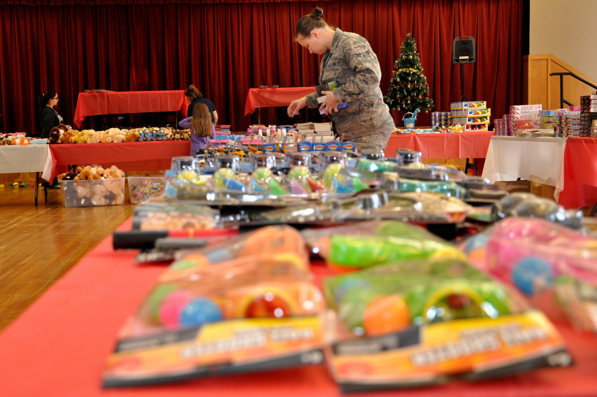 Volunteers organize toys before Operation Homefront Dec. 17, 2013, at Little Rock Base, Ark. Approximately 6,000 toys were distributed to Airmen ranking E-6 and below. (U.S. Air Force photo by Senior Airman Regina Agoha)