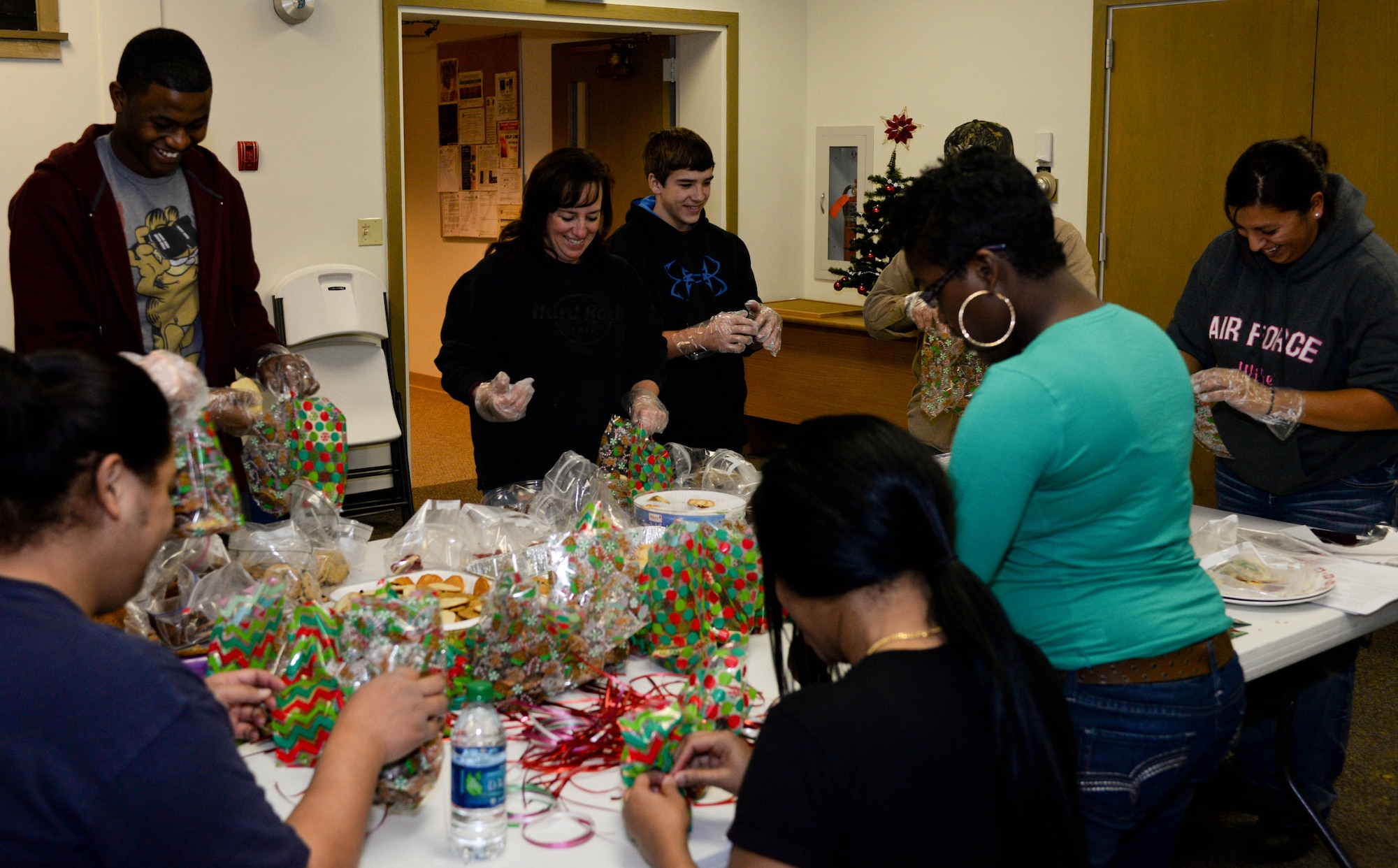 Airmen and volunteers from the Enlisted Spouses Club prepare treats during a holiday cookie drive in the Freedom Chapel at Ellsworth Air Force Base, S.D., Dec. 12, 2013. The event was conducted as a way of promoting holiday cheer and thanking Airmen for their service. (U.S. Air Force photo by Senior Airman Zachary Hada/Released)