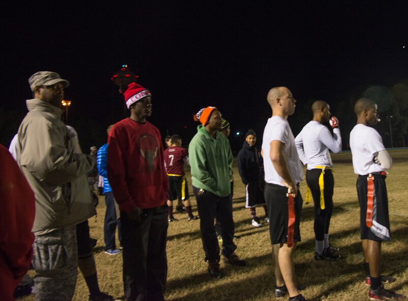Spectators watch the 23d Medical Group and 23d Logistics Readiness Squadron face off during an intramural flag football championship game at Moody Air Force Base, Ga., Dec. 17, 2013. The 23d MDG defeated the 23d LRS 24-21, earning their first championship title since 2010. (U.S. Air Force photo by Airman Dillian Bamman/Released)