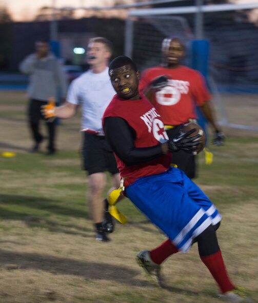 U.S. Air Force Staff Sgt. Frank J. Hayden, 38th Rescue Squadron NCO in charge of medical logistics, makes a first-down conversion during an intramural flag football championship game at Moody Air Force Base, Ga., Dec. 17, 2013. The play led to the 23d Medical Group’s first touchdown of the game against the 23d Logistics Readiness Squadron. (U.S. Air Force photo by Airman Dillian Bamman/Released)