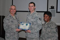 Col. Robert Vercher, 91st Missile Wing commander and Chief Master Sgt. Fay Noil, 91st Missile Wing command chief, step promote Staff Sgt. Jeremy D. Roberts to the rank of Technical Sgt. here, Dec. 19, 2013. Step promotions reward outstanding airmen who work hard and perform superbly. (Courtesy photo)
