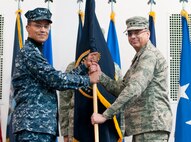 Admiral Cecil D. Haney, commander, U.S. Strategic Command, presents the Task Force 214 guidon to Maj. Gen. Jack Weinstein as Weinstein assumes command of the task force during an assumption of command ceremony at the Fall Hall Community Center on F.E. Warren Air Force Base, Wyo., Dec. 19, 2013. Weinstein also assumed command, during the same ceremony, of the 20th Air Force from Lt. Gen. Stephen Wilson, commander, Air Force Global Strike Command. Weinstein is responsible for providing on-alert, combat ready ICBMs to the President of the United States. (U.S. Air Force photo by R.J. Oriez)