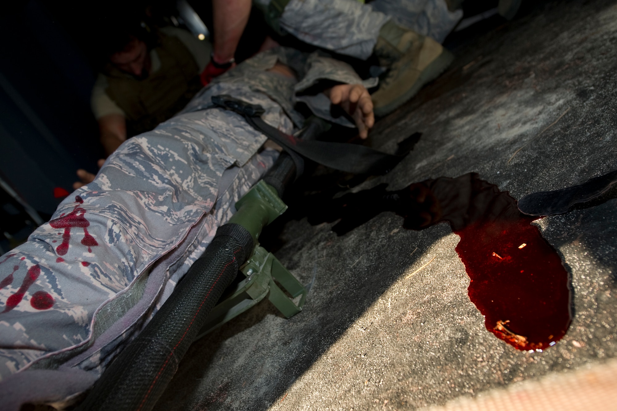 Synthetic blood drips from a simulated critically wounded patient during the Casualty Evacuation course on Hurlburt Field, Fla., Dec. 18, 2013. CASEVAC course students are required to treat life-like patients in a simulated combat environment. (U.S Air Force photo/Senior Airman Naomi Griego)