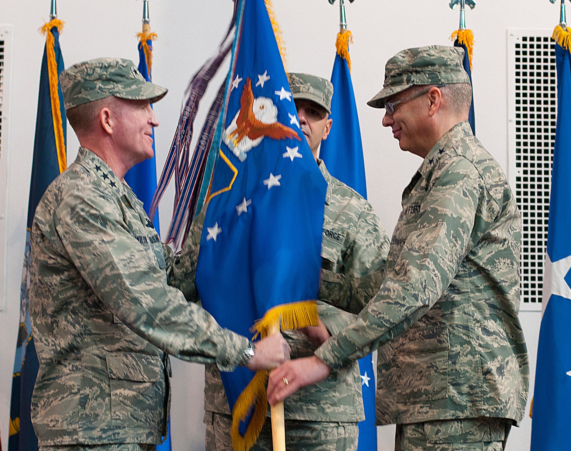 Lt. Gen. Stephen Wilson, commander, Air Force Global Strike Command, presents the 20th Air Force guidon to Maj. Gen. Jack Weinstein as Weinstein assumes command of the numbered Air Force, responsible for maintaining and operating the Air Force’s ICBM force, during an assumption of command ceremony at Fall Hall Community Center on F.E. Warren Air Force Base, Dec. 19, 2013. Weinstein also assumed command, during the same ceremony, of U.S. Strategic Command’s Task Force 214 from Adm. Cecil Haney, commander, USSTRATCOM. Weinstein is responsible for providing on-alert, combat ready ICBMs to the President of the United States. (U.S. Air Force photo by R.J. Oriez)