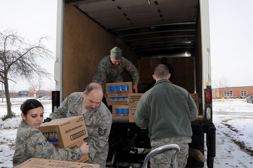 Members of the 178th Fighter Wing load a truck with collected food items to deliver to Second Harvest Food Bank, Springfield, Ohio Dec. 19. The food was collected as part of a food drive put on by the Airman/NCO Council. (U.S. Air Force photo by SSgt. Elisabeth Gelhar, cleared for release)