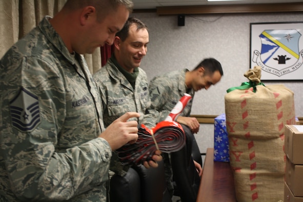 From left, Master Sgt. Benjamin Kastama, Tech. Sgt. Clint Abston and Master Sgt. Michael Mowatt, all with the 552nd Aircraft Maintenance Squadron, get care packages ready to send to deployed Airmen. (Air Force photo by Master Sgt. Ericson T. Wolford)