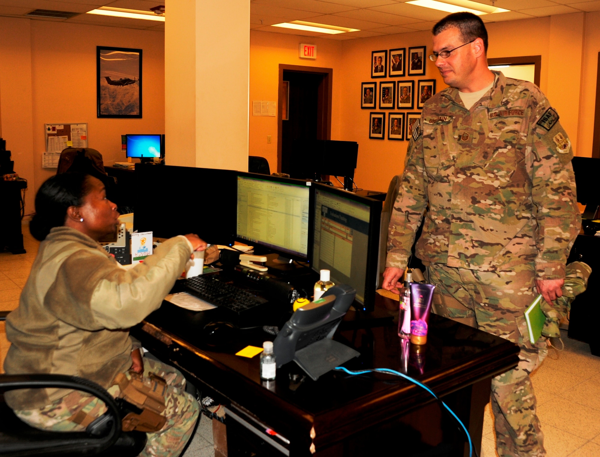 Master Sgt. Jeremy Brittain, 455th Air Expeditionary Wing superintendent of chapel operations, speaks to Master Sgt. Tammisha McCoy, 455th AEW knowledge operations manager, during one of his daily visits to various base agencies. Brittain and Lt. Col. Bill Johnson, 455th AEW chaplain, work as a pair on a religious support team. Brittain is a native of Morganton, S.C., and is deployed from Joint Base McGuire-Dix-Lakehurst, N.J. McCoy is a native of Rockford, Ill., and is deployed from Nellis Air Force Base, Nev. (U.S. Air Force photo by 1st Lt. Alexis McGee/Released)