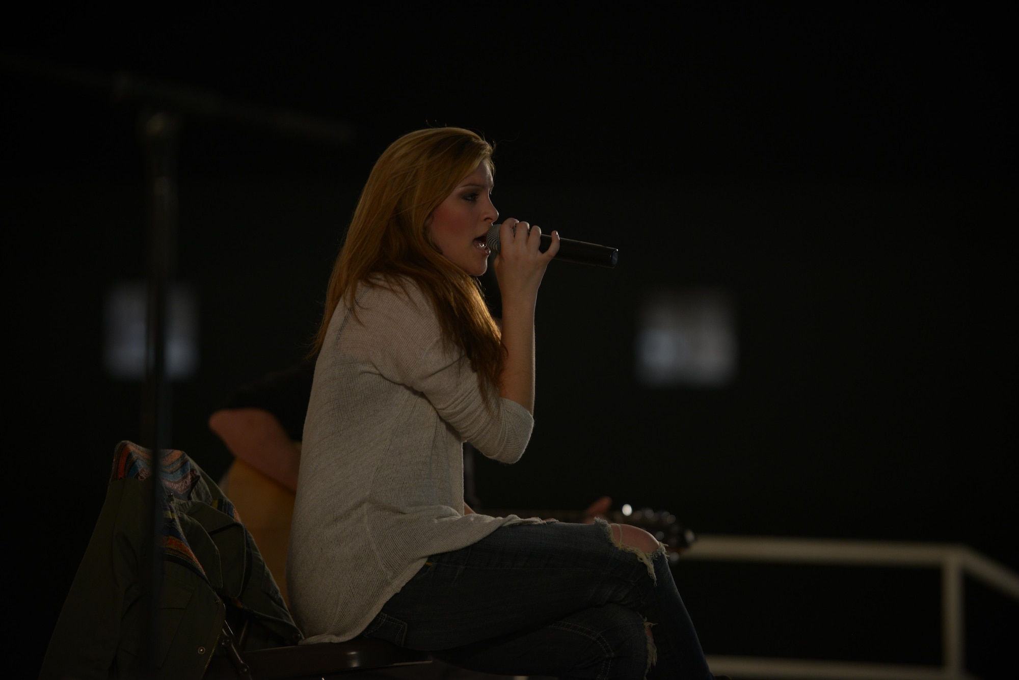 Alaina Blair, a country music artist, performs for service members at the 379th Air Expeditionary Wing in Southwest Asia, Dec. 19, 2013.  Blair, along with her band, performed 11 concerts in five countries across the U.S. Air Forces Central Command area of responsibility over an 18 day period. Completing the Armed Forces Entertainment tour here, Blair sang a mix of her own music, cover songs and Christmas carols to the audience, providing an interactive performance while spreading holiday cheer. (U.S. Air Force photo by Master Sgt. David Miller)