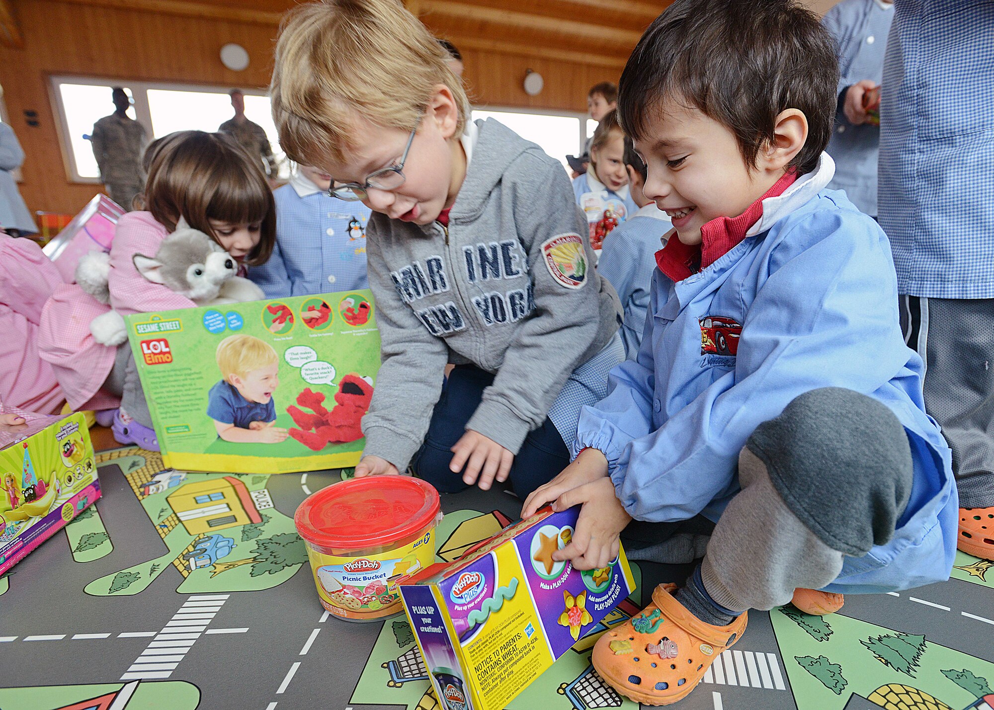 Italian children receive presents from Team Aviano, Dec. 19, 2013, at the Aviano Azilo, Italy. This year, Airmen donated gifts to children, ages 3 to 5 years old, through a campaign known as ‘Toys for Tots’. The month-long campaign’s donations were distributed with the help of the Aviano Chapter Italy-Hog motorcycle club. (U.S. Air Force photo/Airman 1st Class Deana Heitzman) 