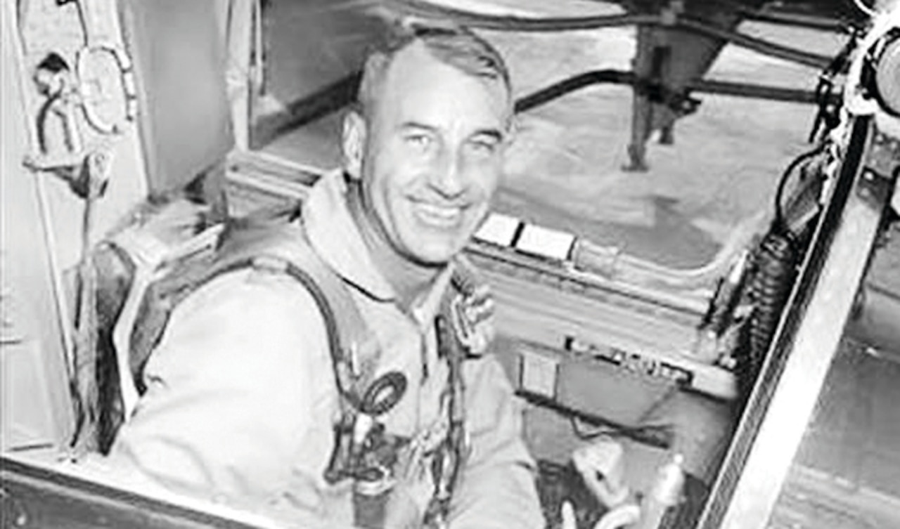 Air Force Col. Harry Shoup sits in the cockpit of a plane.