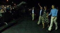 President of the United States Barack Obama and First Lady Michelle Obama wave and say their "Hellos" to Airmen and their families upon their arrival to the Hickam flightline at Joint Base Pearl Harbor-Hickam, Hawaii on Dec. 20, 2013. President Obama, a native of Hawaii, is home for the Holidays. (U.S. Air Force photo/Master Sgt. Jerome S. Tayborn)