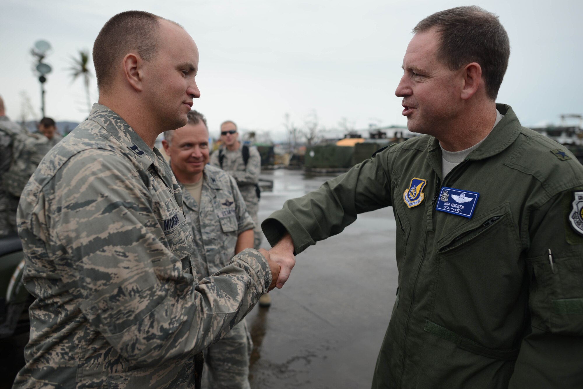 Capt. Clark Morgan, 36th Mobility Response Squadron Contingency Engineering Flight commander, shakes the hand of Brig. Gen. Jim Hecker, 18th Wing commander, Nov, 23, 2013, during Operation Damayan in Tacloban, Philippines. Operation Damayan is a humanitarian aid and disaster relief operation led by the Philippine government and supported by a multinational response force. (U.S. Air Force photo by 2nd Lt. Jake Bailey/Released)