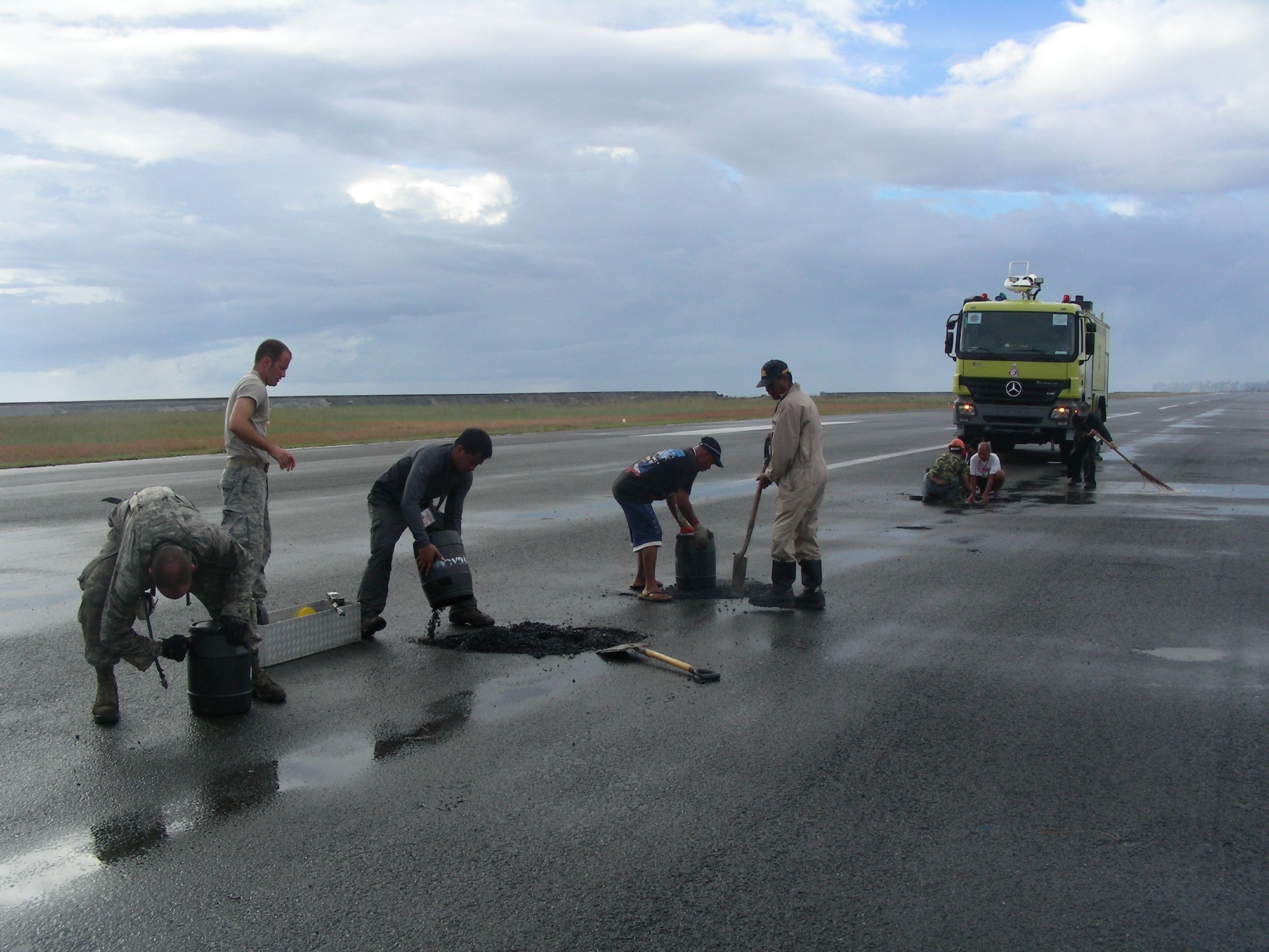 Airmen and host nation volunteers fix damaged areas of the flightline Nov. 24, 2013, during Operation Damayan in Tacloban, Philippines. Operation Damayan is a humanitarian aid and disaster relief operation led by the Philippine government and supported by a multinational response force. (Courtesy photo)