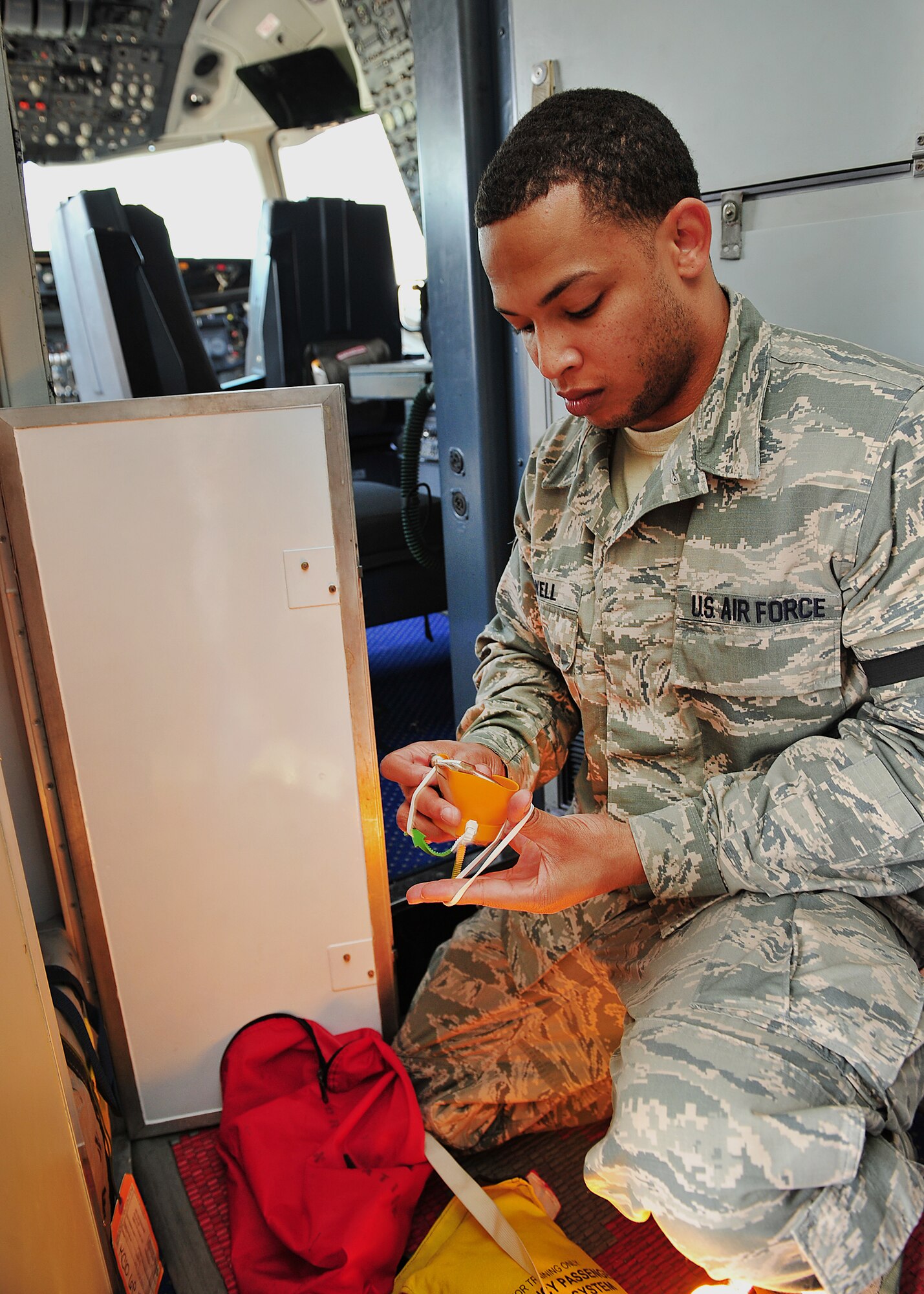 Air Force Staff Sgt. Tralves Sowell, 380th Expeditionary Operations Support Squadron KC-10 Aircrew Flight Equipment NCO in charge, cleans and inspects equipment at an undisclosed location in Southwest Asia, Dec. 17, 2013. Sowell a native from Pageland, S.C., and is deployed here from Joint Base McGuire-Dix-Lakehurst, N.J. (U.S. Air Force photo by Staff Sgt. Michael Means/Released)