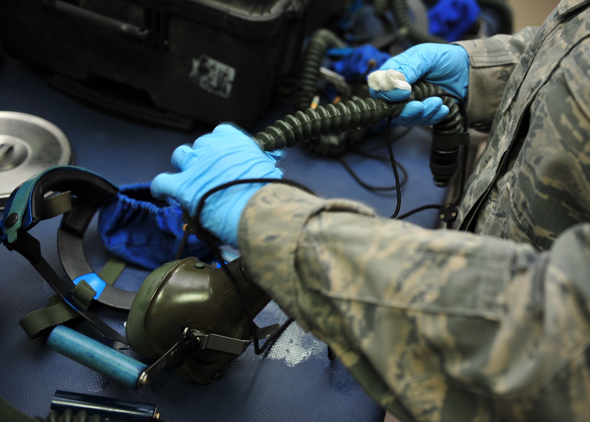 Air Force Airman 1st Class Prestley Thompson, an Aircrew Flight Equipment techncian assigned to the 380th Expeditionary Operations Support Squadron here, cleans and inspects equipment at an undisclosed location in Southwest Asia, Dec. 17, 2013. Thompson is deployed from Tinker, Okla. (U.S. Air Force photo by Staff Sgt. Michael Means/Released)