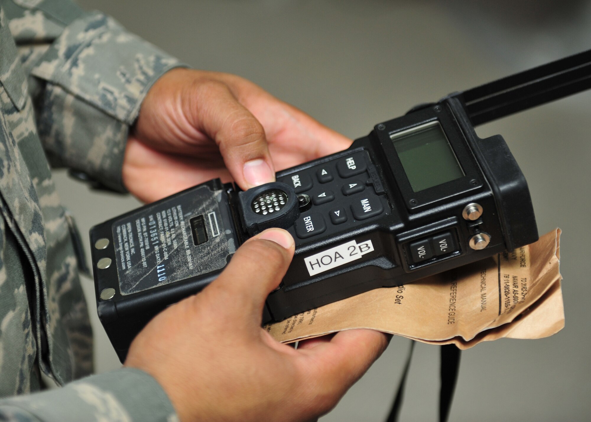 Air Force Staff Sgt. Joshua Taylor, an Aircrew Flight Equipment technician assigned to the 380th Expeditionary Operations Support Squadron here, calibrates a radio at an undisclosed location in Southwest Asia, Dec. 17, 2013. Taylor calls Charlotte, N.C., home and is deployed from Joint Base McGuire-Dix-Lakehurst, N.J. (U.S. Air Force photo by Staff Sgt. Michael Means/Released)