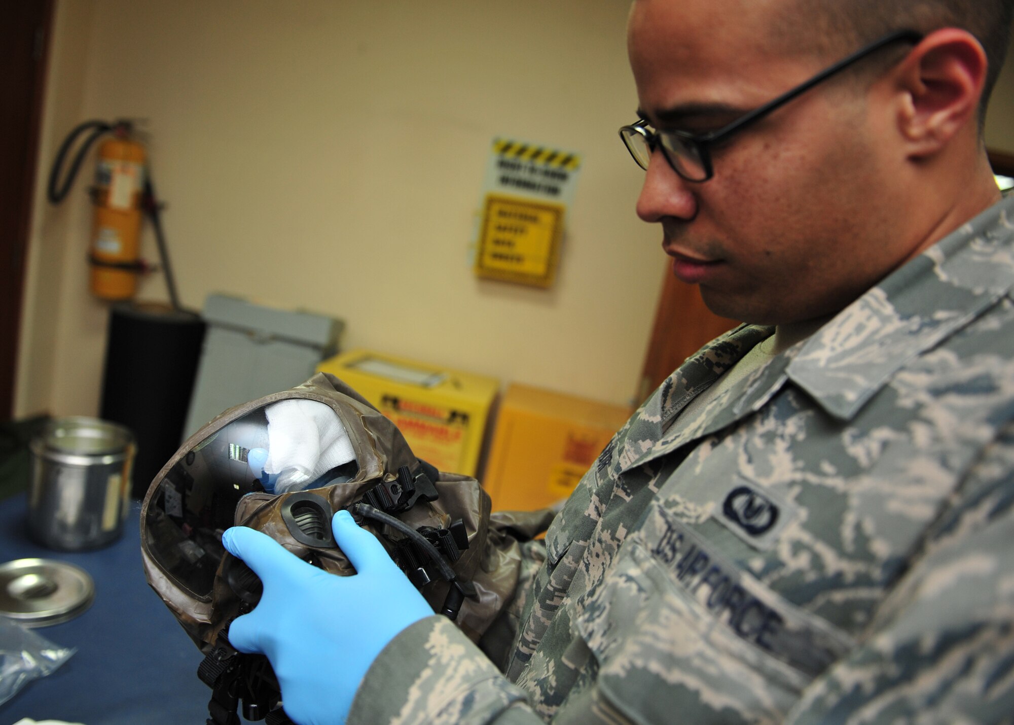 Air Force Staff Sgt. Joshua Taylor, an Aircrew Flight Equipment technician assigned to the 380th Expeditionary Operations Support Squadron here, cleans and inspects equipment at an undisclosed location in Southwest Asia, Dec. 17, 2013. Taylor calls Charlotte, N.C., home and is deployed from Joint Base McGuire-Dix-Lakehurst, N.J. (U.S. Air Force photo by Staff Sgt. Michael Means/Released)