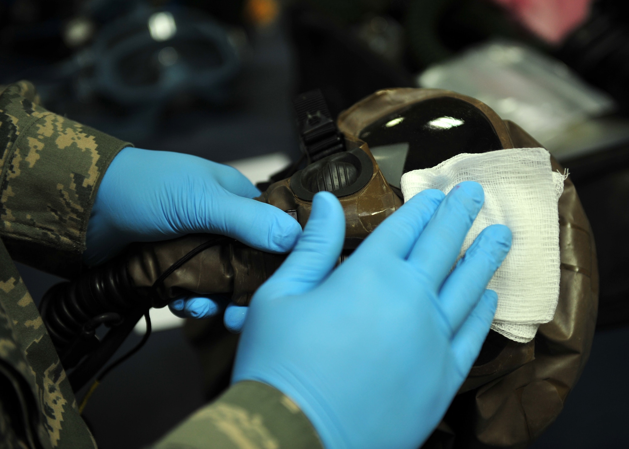 Air Force Staff Sgt. Joshua Taylor, an Aircrew Flight Equipment technician assigned to the 380th Expeditionary Operations Support Squadron here, cleans equipment at an undisclosed location in Southwest Asia, Dec. 17, 2013. Taylor calls Charlotte, N.C., home and is deployed from Joint Base McGuire-Dix-Lakehurst, N.J. (U.S. Air Force photo by Staff Sgt. Michael Means/Released)