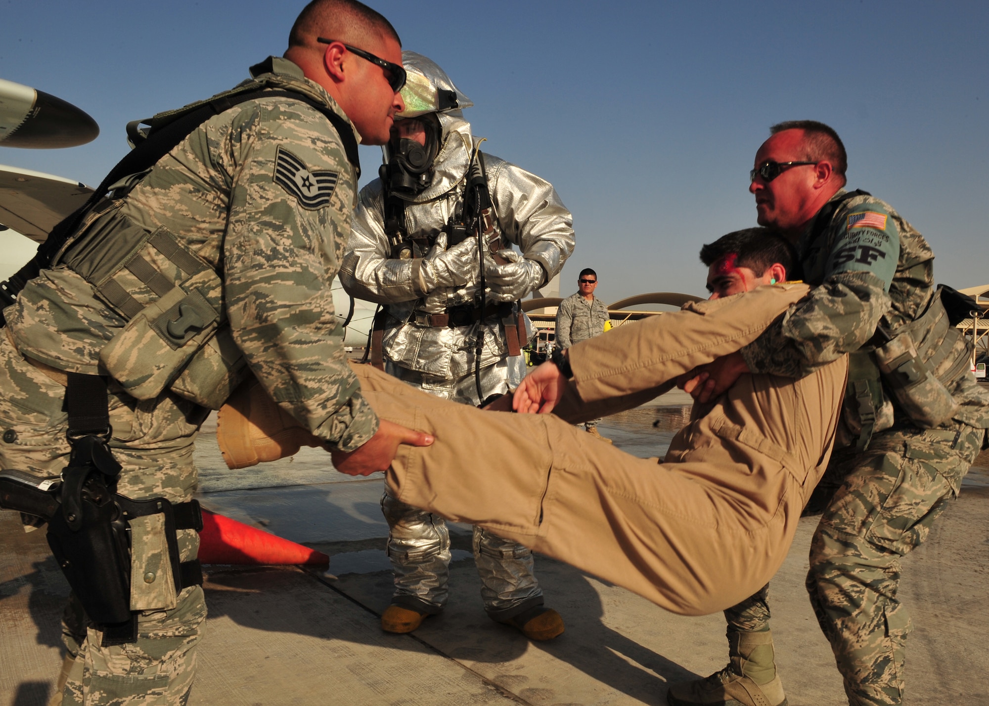 First responders assigned to the 380th Air Expeditionary Wing carry a victim to safety during a Major Accident Response Exercise at an undisclosed location in Southwest Asia, Dec. 19, 2013. The MARE is to ensure members of the wing can appropriately respond to a major accident. (U.S. Air Force photo by Staff Sgt. Michael Means/Released)