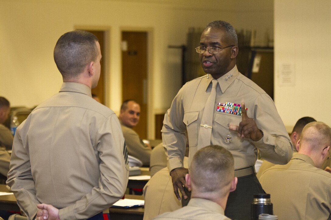 U.S. Marine Corps Lt. Gen. Ronald L. Bailey, the deputy commandant of Plans, Policies and Operations, speaks with U.S. Marine Corps Sgt. Robert R. Burk, a recruiter with Marine Corps Recruiting Station Baltimore and a native of Milford, Del., during a monthly training session for RS Baltimore and RS Frederick at the American Legion in Laurel, Md., Dec. 19, 2013. Bailey, a native of Saint Augustine, Fla., spoke with more than 150 Marine recruiters concerning how to excel at being promoted, the reduction and restructuring of the Marine Corps and the gradual shift of Marines toward the Pacific theater of operations. (U.S. Marine Corps photo by Cpl. Bryan Nygaard/Released)