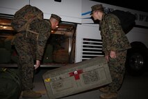 Two Marines from Marine Heavy Helicopter Squadron (HMH) 464 load gear onto a bus before their departure to Japan, Dec. 12. Approximately 50 Marines of HMH-464 left their hangar aboard Marine Corps Air Station New River to deploy to Japan as part of the Unit Deployment Program, Dec. 2.