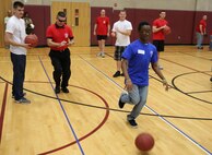 A Special Olympics athlete dribbles a basketball down a designated area on the court while being timed to see how many points he can rack up toward his score. Marine Corps Air Station New River, in partnership with Special Olympics Onslow County hosted the 14th annual Special Olympics Fall Games at the AS-4400 fitness center, Dec. 6.
