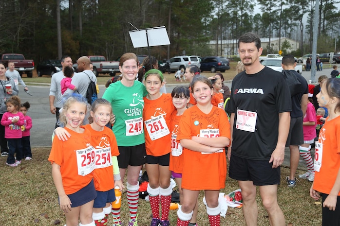 Girls on a Run participants from Delalio Elementary School aboard Marine Corps Air Station New River, N.C., pose for a run after their 5K run, Dec. 7.