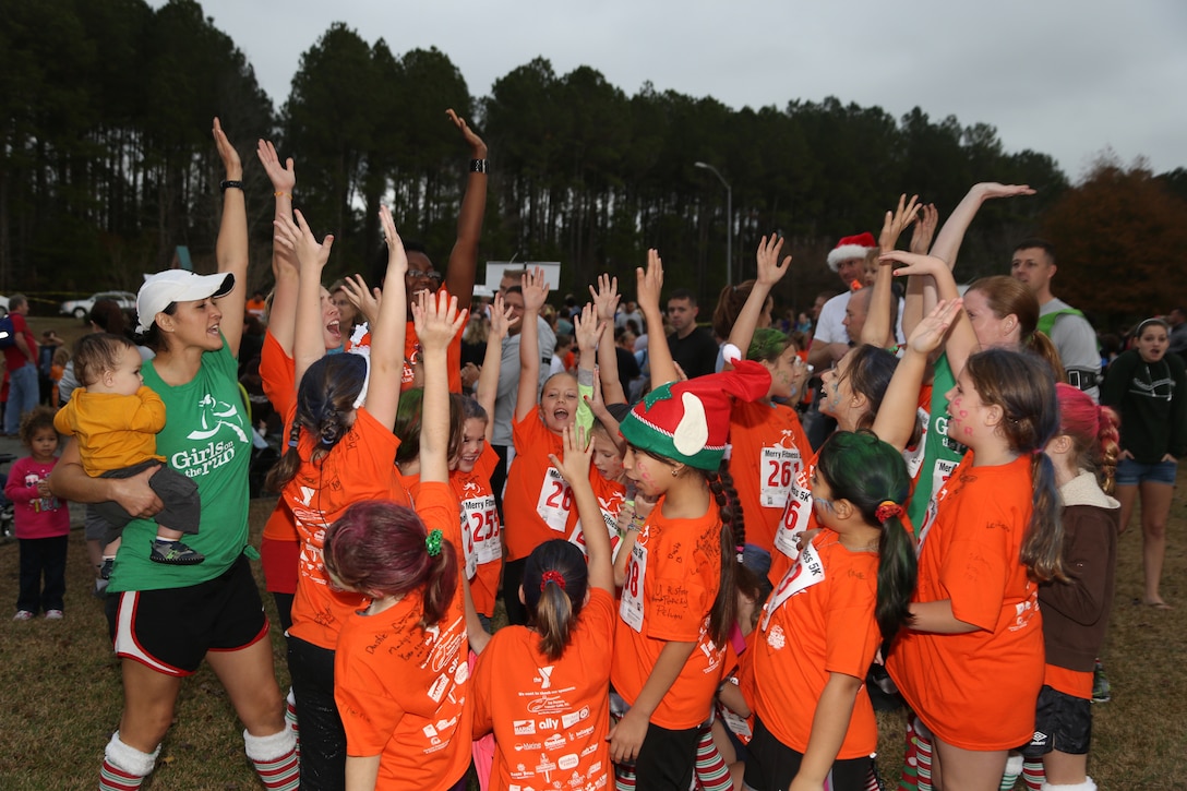 Girls from Delalio Elementary School aboard Marine Corps Air Station New River give their group cheer at the semi-annual Girls on the Run celebration, Dec. 7. The group, led by Marines from Marine Corps Aviation Logistics Squadron 29, participated in the 5k as part of the programs cirriculum of promoting self-awareness through physical fitness.