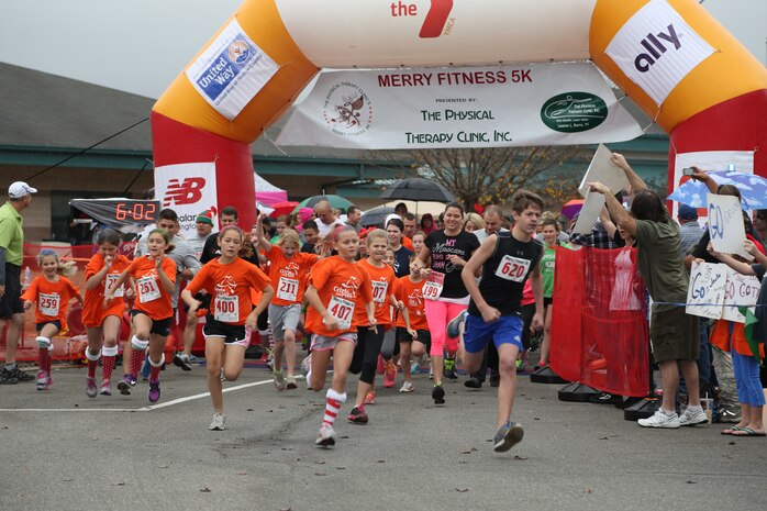 Participants in the Merry Fitness 5k at Jacksonville Commons Elementary school in Jacksonville, N.C., begin their run at the semi-annual Girls on the Run celebration, Dec. 7. A group from Delalio Elementary School aboard Marine Corps Air Station New River, N.C., was led by Marines from Marine Corps Aviation Logistics Squadron 29.