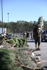Volunteers carry Christmas trees to be given to Marines and Sailors aboard Marine Corps Air Station New River at the Youth Sports Complex as part of the Trees for Troops program, Dec. 12. Since 2005, Trees for Troops has given more than 100,000 live Christmas trees to service members and their families.
