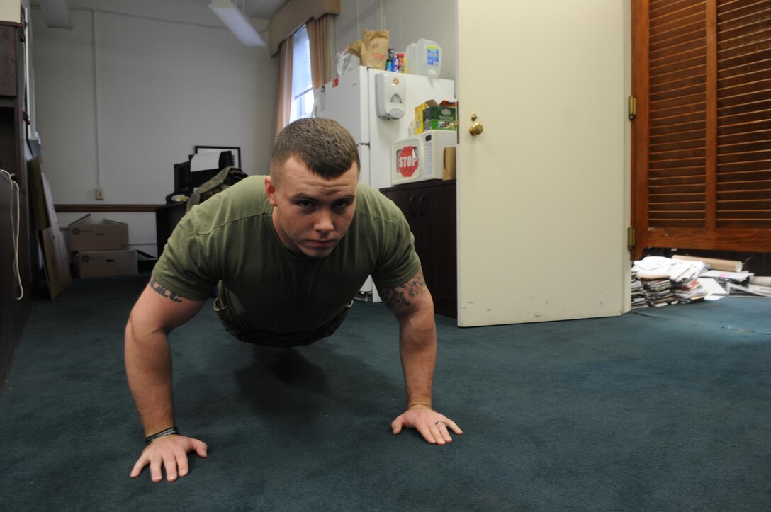 Cpl. Stephen Dillon, the base commander’s driver, executes a set of pushups, one of many simple exercises recommended for indoor physical training, at Lejeune Hall on Dec. 17, 2013. 