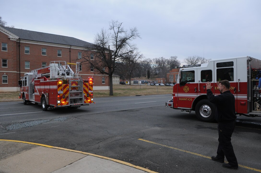 Firefighter Doug Butler guides a fire truck as it backs into the fire station on Barnett Avenue on Dec. 20, 2013. The station’s firefighters said motorists sometimes try to pass around the trucks while they’re backing in, endangering the firefighters who get out to assist the driver. 
