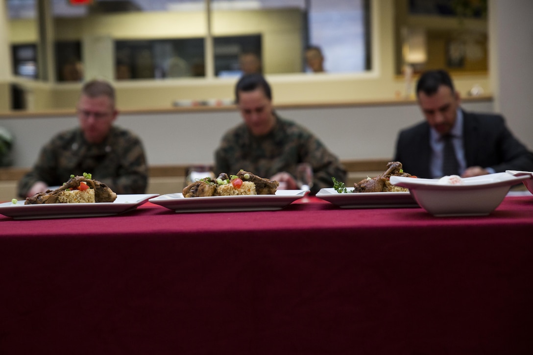 Lt. Col. Richard Kohler(left), commanding officer of the Marine Corps Food Service and Assistance Program, Sgt. Maj. Angela Maness(middle), Marine Barracks Washington, D.C. sergeant major, and Mr. Frank Alanis(right), contracting officer for the food service, sit as judges during the Culinary Team of the Quarter competition at Marine Barracks Washington, D.C., Dec. 17. The event pitted the food service Marines against the civilian workers in a cookoff. (Official Marine Corps photo by Lance Cpl. Dan Hosack/Released)