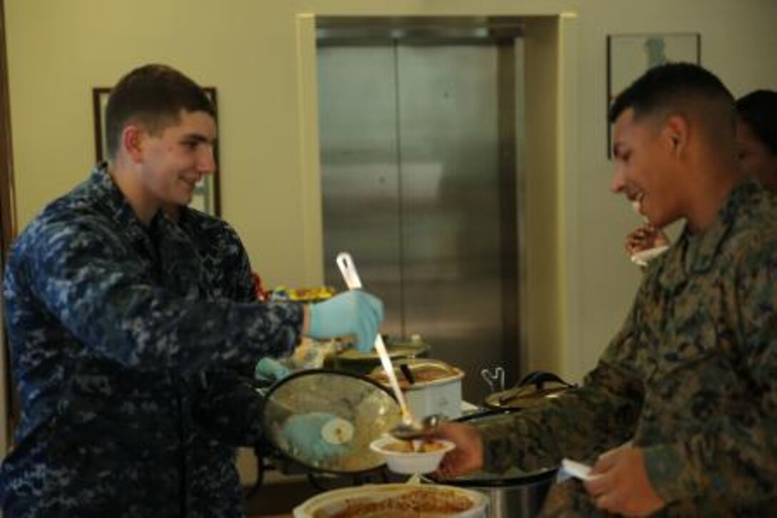 Seaman Chris Hilliard, left, serves a scoop of chili during Marine Corps Air Station Cherry Point’s Naval Health Clinic chili cook-off fundraiser in support of the Combined Federal Campaign Dec. 18. Hilliard is a corpsman at the NHC.


