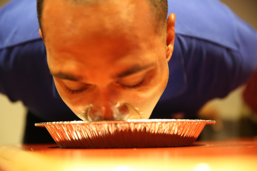 Pfc. Jodson B. Graves, a combat photographer with Marine Wing Headquarters Squadron 2, participates in a pie eating contest during the Big Chill event at the Roadhouse Dec. 17.
