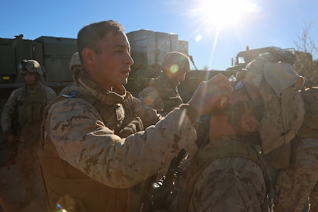 Petty Officer 3rd Class Moulay A. Bounouar, a corpsman with Combat Logistics Battalion 5, Combat Logistics Regiment 1, 1st Marine Logistics Group, provides basic first aid to a Marine during Exercise Steel Knight 2014 aboard Marine Corps Air Ground Combat Center Twentynine Palms, Calif., Dec. 13, 2013. The corpsmen with CLB-5 provided medical care for Marines and sailors and taught tactical combat casualty care classes to prepare them for deployment. SK14, which took place Dec. 09-16, is an annual exercise designed to prepare the 1st Marine Division for deployment with the Marine Air-Ground Task Force as the Ground Combat Element with the support of 1st MLG and 3rd Marine Air Wing. Combined, the MAGTF is able to deploy and respond in a timely manner to any situation across the globe.