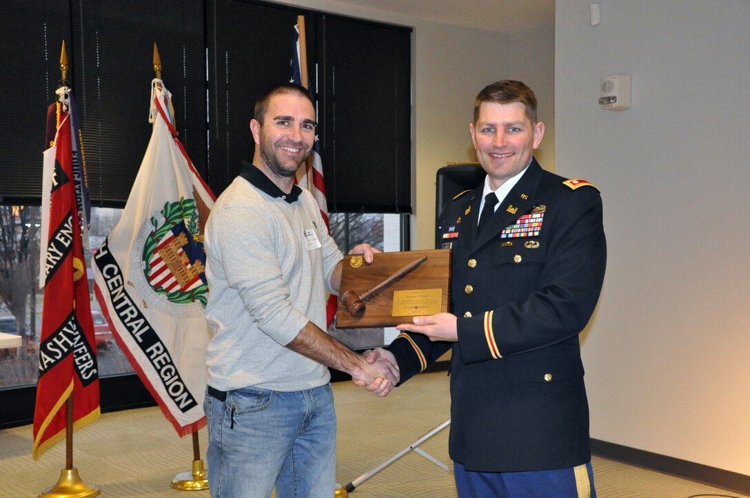 Lt. Col. John Hudson, U.S. Army Corps of Engineers Nashville District commander, presents outgoing President Bryon Olsen a plaque after being installed as president of the Society of American Military Engineers Nashville Post during a meeting Dec. 18, 2013 in the Tennessee Engineering Center at the Adventure Science Center in Nashville, Tenn. (USACE photo by Mark Rankin) 