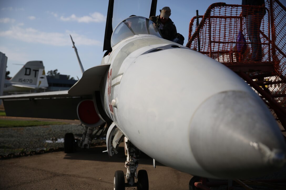 Ron Lewis, the foundation historian at The Flying Leatherneck Aviation Museum, assists families into the cockpit of an F/A-18 Hornet aboard Marine Corps Air Station Miramar, Calif., Nov. 17. The museum celebrated the F/A-18’s 35th anniversary of its first flight with the aircraft itself on display and models of the aircraft with additional information indoors.


