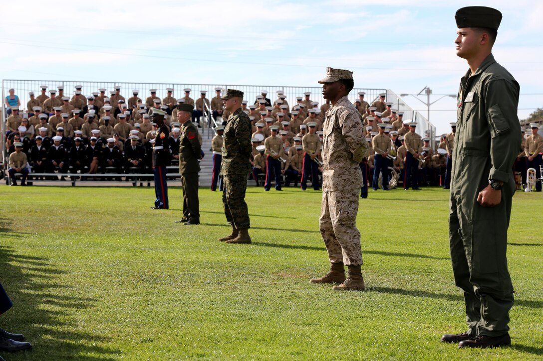 Marines display the Marine Corps uniforms during a cake cutting ceremony in honor of the 238th birthday of the Marine Corps aboard Marine Corps Air Station Miramar, Calif., Nov. 7. The ceremony symbolized the passing of wisdom from the oldest Marine to the youngest Marine.



