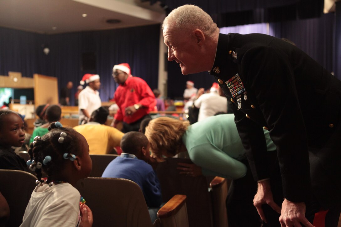 NEW ORLEANS – Lt. Gen. Richard P. Mills, commander of Marine Forces Reserve and Marine Forces North, takes a moment to talk to one of the many children that flooded a U.S. Marine Corps Toys for Tots event hosted by the Zulu Social Aid and Pleasure Club at New Orleans City Hall, Dec. 21, 2013. (Official photo by Sgt. Fenton Reese)