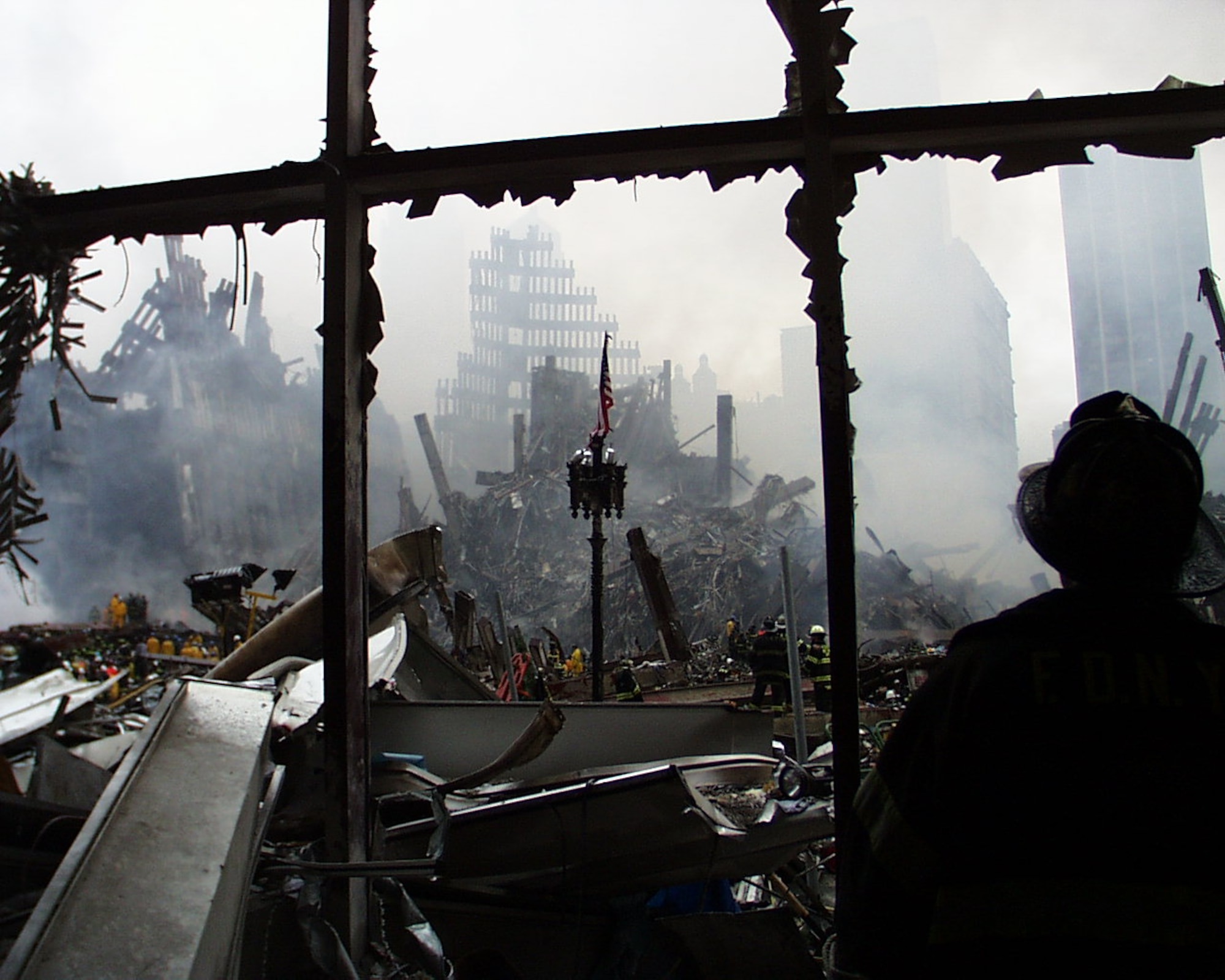 Then-Senior Master Sgt. Paul Koester snaps a shot of rescue operations at the base of the twin towers Sept. 11, 2001. Koester and fellow guardsmen reported to Ground Zero soon after the towers were attacked. Koester was a guardsman at the time with the 102nd Rescue Squadron at Gabresky Air National Guard Base in Long Island, N.Y., just 64 miles from the twin towers. Koester and his teammates found the last live survivor in the rubble and carried her in a Stokes litter through the debris to safety. Now-Chief Master Sgt. Paul Koester is currently the oldest Airman serving on active-duty. Koester is the Pararescue Functional Manager for the Battlefield Airmen Branch at Pacific Air Forces Headquarters here. Koester calls Colorado Springs, Colo., home. (Courtesy photo by Chief Master Sgt. Paul Koester/Released)